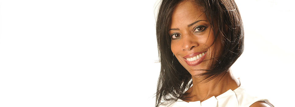 headshot of smiling woman in white dress