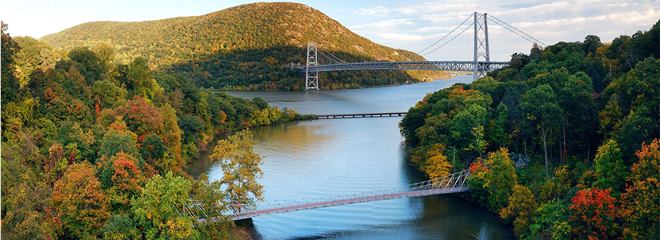 three bridges spanning over a large river in the Fall